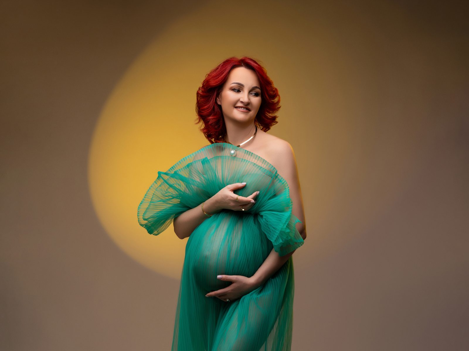 Studio maternity photo session in Bucharest — green tulle gown and studio light